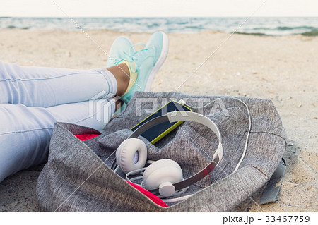 Women's legs in jeans and sneakers, backpack Women's legs in jeans and sneakers, backpack 33467759