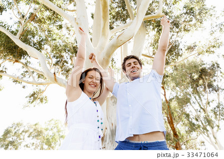 Young couple in the park celebrating 33471064