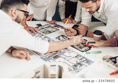 Team of architects working on construction plans Team of architects working on construction plans 33476605