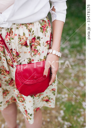 Closeup red bag in hands of woman on the street Closeup red bag in hands of woman on the street 33478176
