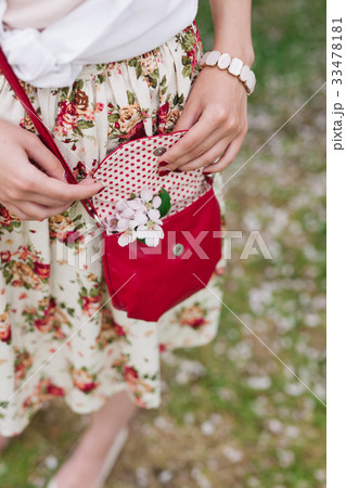 Closeup red bag in hands of woman on the street Closeup red bag in hands of woman on the street 33478181
