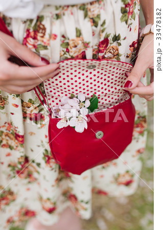 Closeup red bag in hands of woman on the street Closeup red bag in hands of woman on the street 33478182