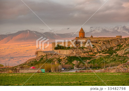 Ancient monastery in front of mountain 33482798