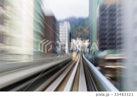 Blurred motion moving train to city downtown 33483321