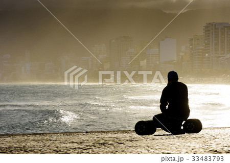 Skateboarder looking at the sea 33483793