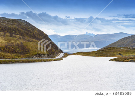 Asphalt curved road along mountain, Tromso, Norway 33485089