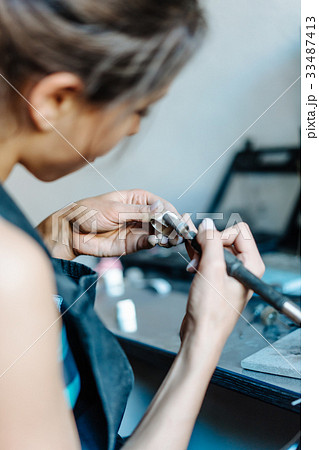 The girl is engaged in jewelry business The girl is engaged in jewelry business 33487413