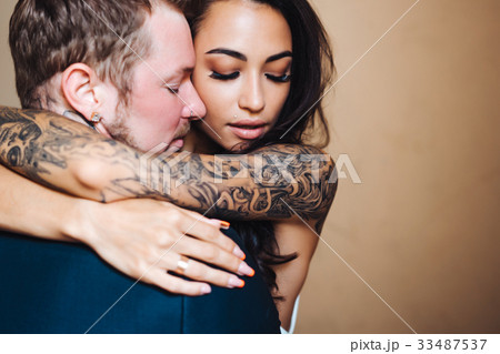 Beautiful, young couple posing on camera indoors 33487537