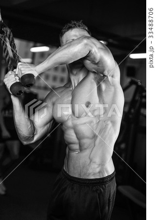 Caucasian sexy fitness model in gym close up abs. 33488706