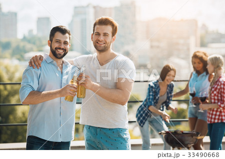 Group of friends having barbecue party on the roof Group of friends having barbecue party on the roof 33490668