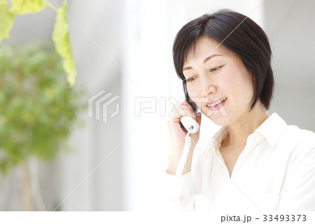 固定電話で話す女性 33493373