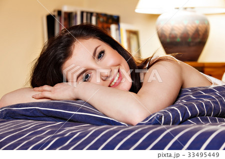 Young woman sleeping on the bed-clothes in bed 33495449
