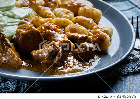 Italian potato dumplings with stew and salad 33495878