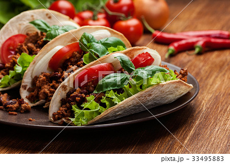 Mexican tacos with minced meat, beans and spices 33495883
