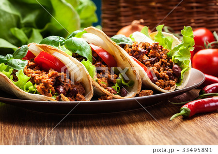 Mexican tacos with minced meat, beans and spices 33495891