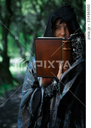 Young witch with magic book Young witch with magic book 33496000