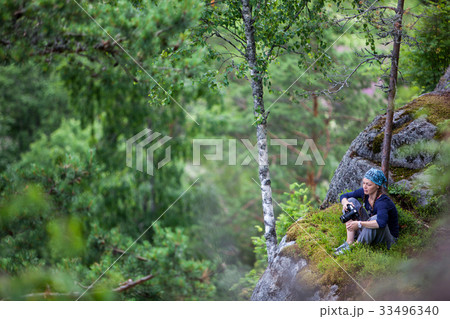 Beautiful girl tourist stands on a rock to 33496340
