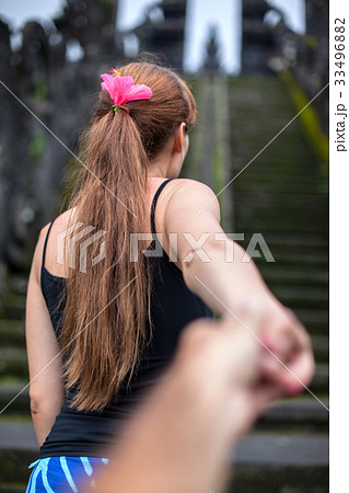 A young woman climbs the ancient steps to the 33496882