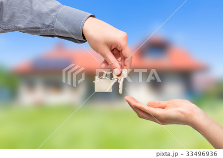 Man is handing a house key to a woman. Real estate concepts. 33496936