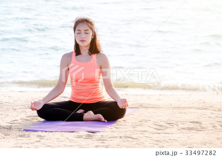 Asian woman close eyes and doing Hand Mudra yoga Asian woman close eyes and doing Hand Mudra yoga 33497282