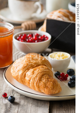 Continental breakfast with croissant, jam and 33499828