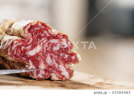 part of dried italian salami on table 33504365