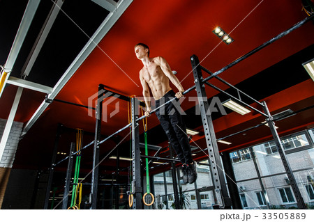 Bar exercises. workout in dark gym 33505889