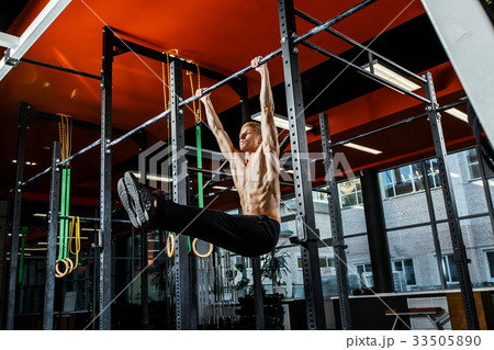 Bar exercises. workout in dark gym 33505890
