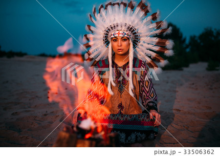 American Indian girl against bonfire, shaman 33506362