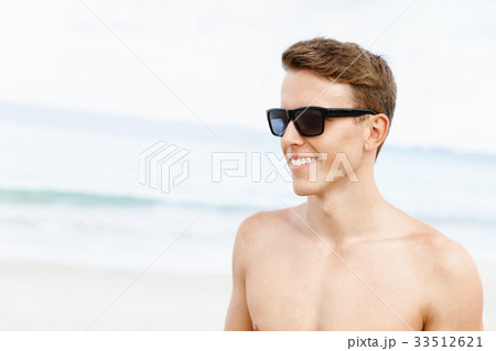 Handsome man posing at beach 33512621