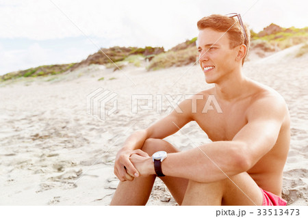 Handsome man posing at beach Handsome man posing at beach 33513473