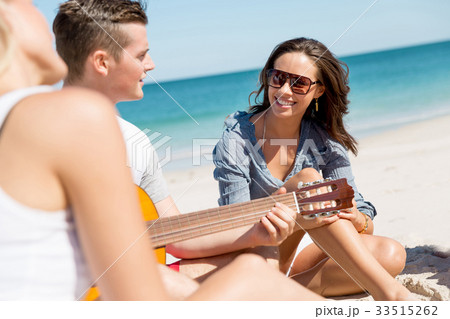 Beautiful young people with guitar on beach Beautiful young people with guitar on beach 33515262