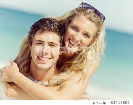 Portrait of man carrying girlfriend on his back Portrait of man carrying girlfriend on his back 33515802