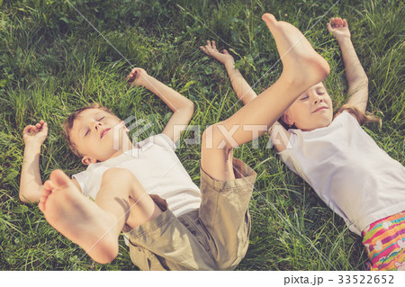 Two happy children playing on the grass at the day time. 33522652