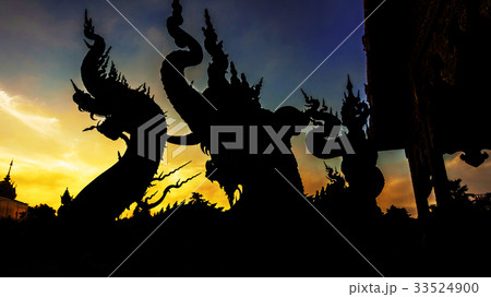 Silhouette dragon statue against twilight sky 33524900