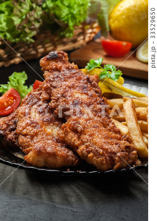 Fried fish in crispy batter with chips 33529650