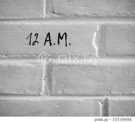 12 A.M. WRITTEN ON WHITE PLAIN BRICK WALL 33539998