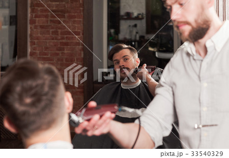 Hipster client visiting barber shop 33540329