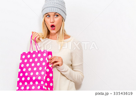 Happy young woman holding a shopping bag 33543619