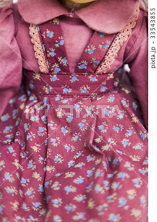 Doll in old textile red dress with floral print Doll in old textile red dress with floral print 33543855