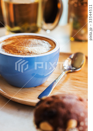 Close up coffee cup with steam on table in cafe. Close up coffee cup with steam on table in cafe. 33544511
