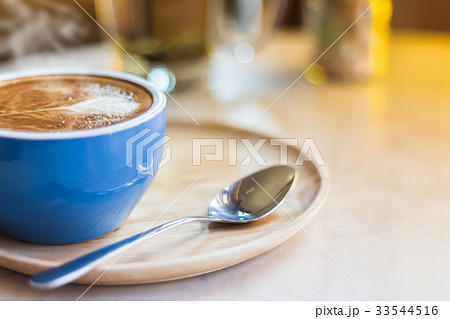Close up coffee cup with steam on table in cafe. Close up coffee cup with steam on table in cafe. 33544516