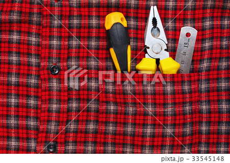 Work tools in work shirt pocket 33545148