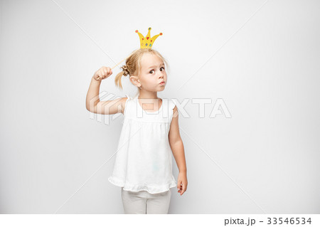 Beautiful little girl with paper crown posing on 33546534