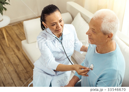 Positive delighted nurse sitting with her patient Positive delighted nurse sitting with her patient 33546670