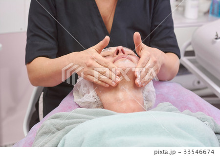 Woman having lymphatic face massage. 33546674