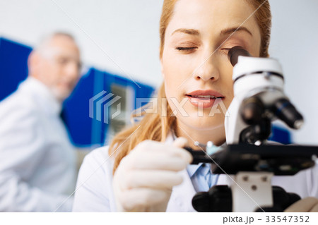 Attentive young scientist examining genes 33547352