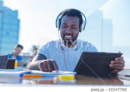 Excited university student reading while studying 33547700