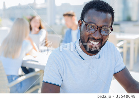 Portrait of african american guy beaming into 33548049