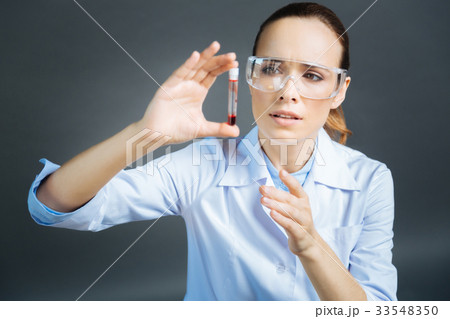 Young medical worker testing blood sample Young medical worker testing blood sample 33548350